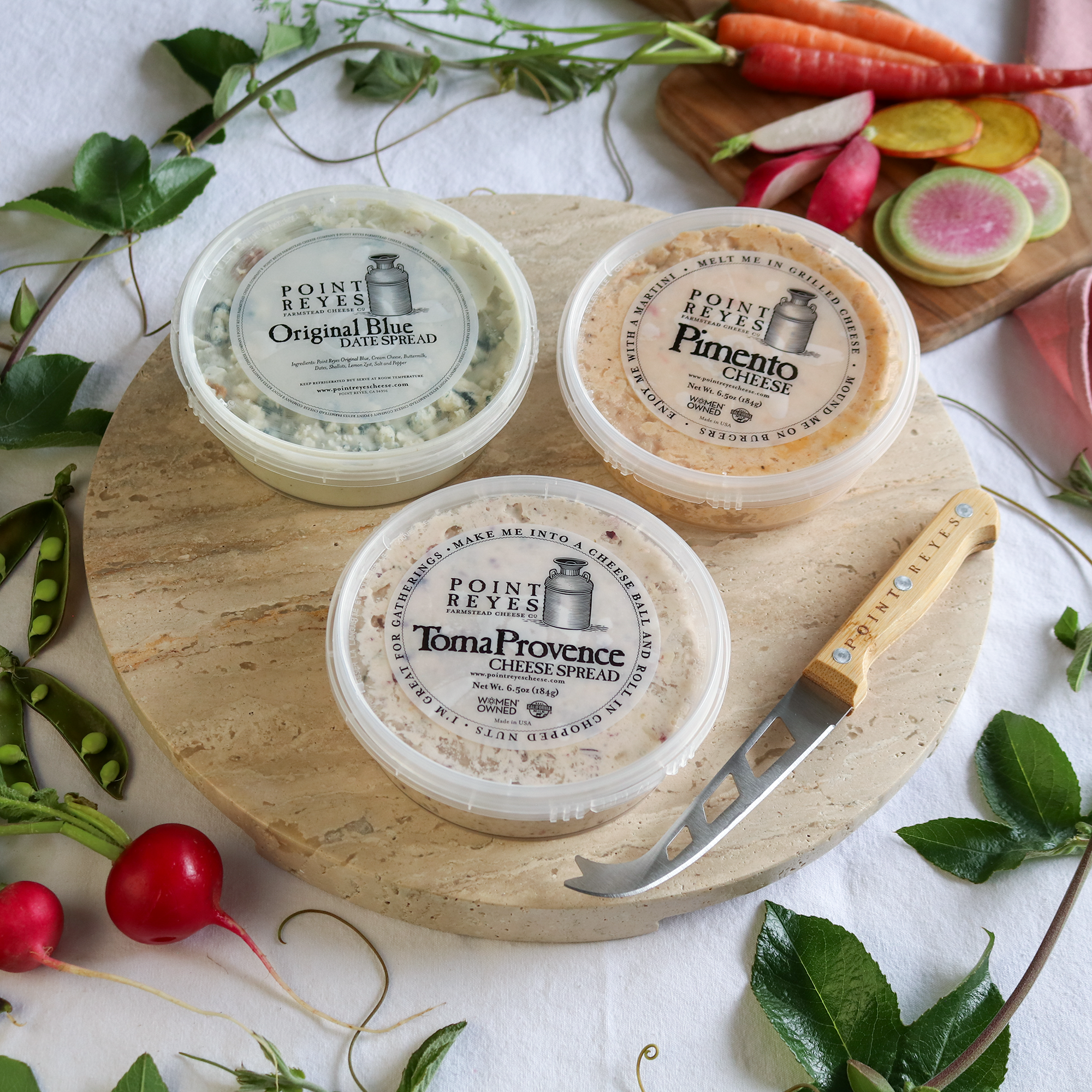 packaged spread the love cheese gift pack on a round board