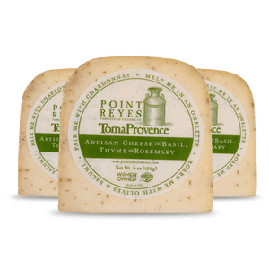 Three blocks of Point Reyes Toma Provèence artisan cheese with labels on a white background