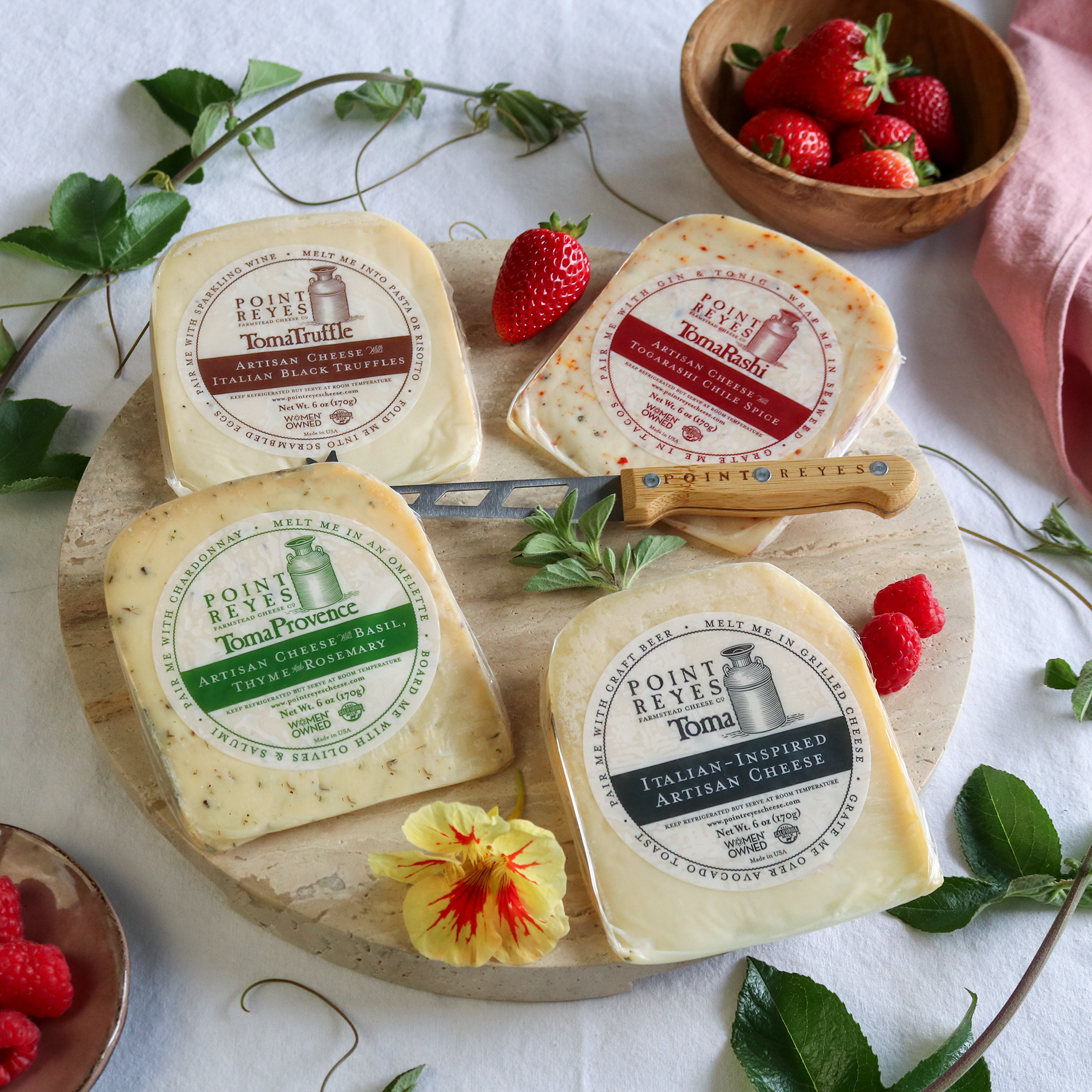 packaged toma with attitude cheese pack on a round board