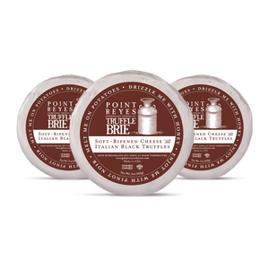 Three containers of Point Reyes Truffle Brie on a white background