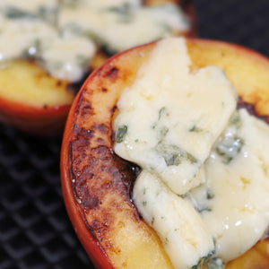 Grilled peaches with melted Bay Blue cheese on top
