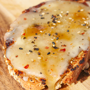Cheesy Toast with TomaRashi cheese, honey, and togarashi on top