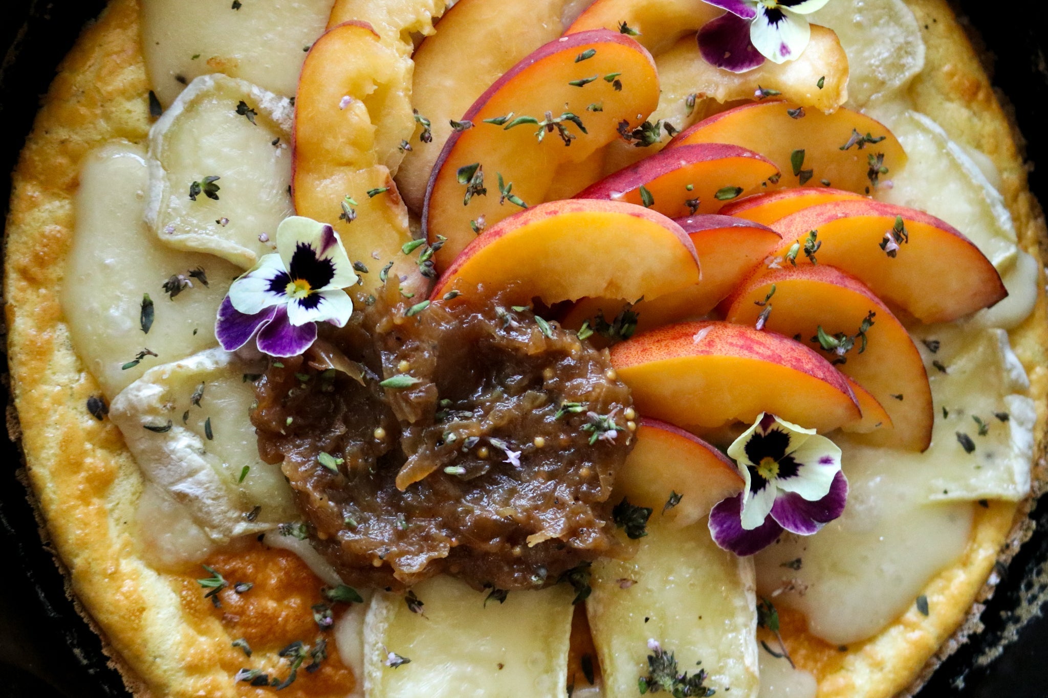 Dutch Baby pancake with brie, peaches and onion jam