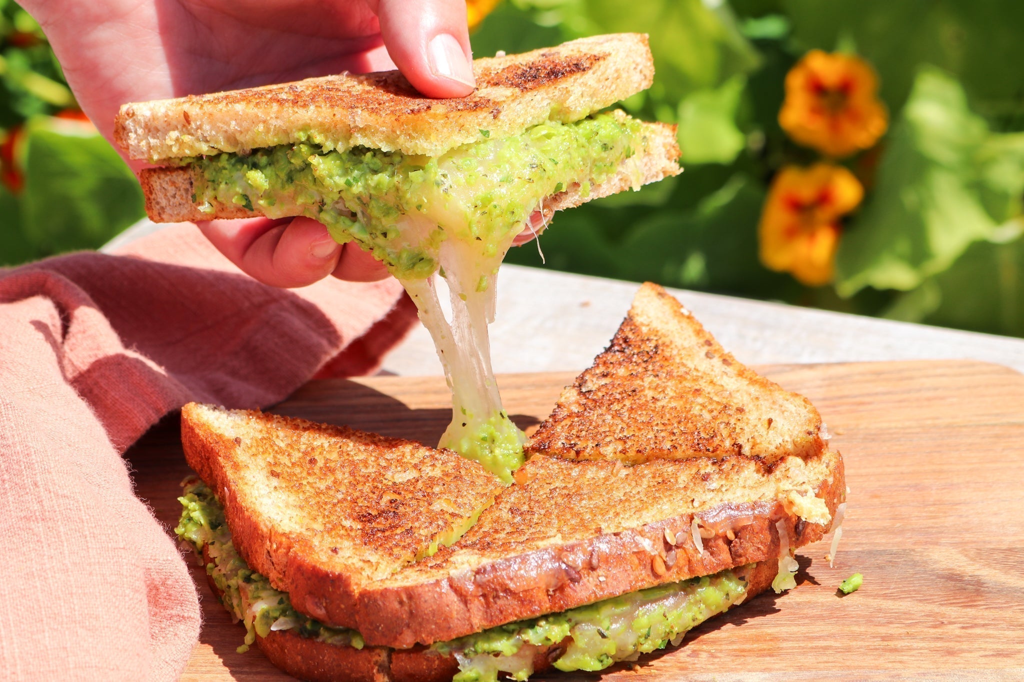 grilled cheese with spring pea puree on a board