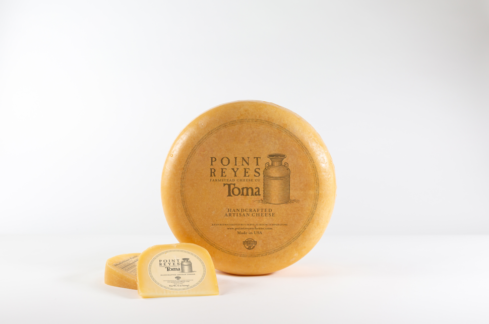 toma cheese wheel and wedge