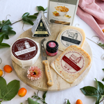 packaged cheese and thank you cheese pack on a round board