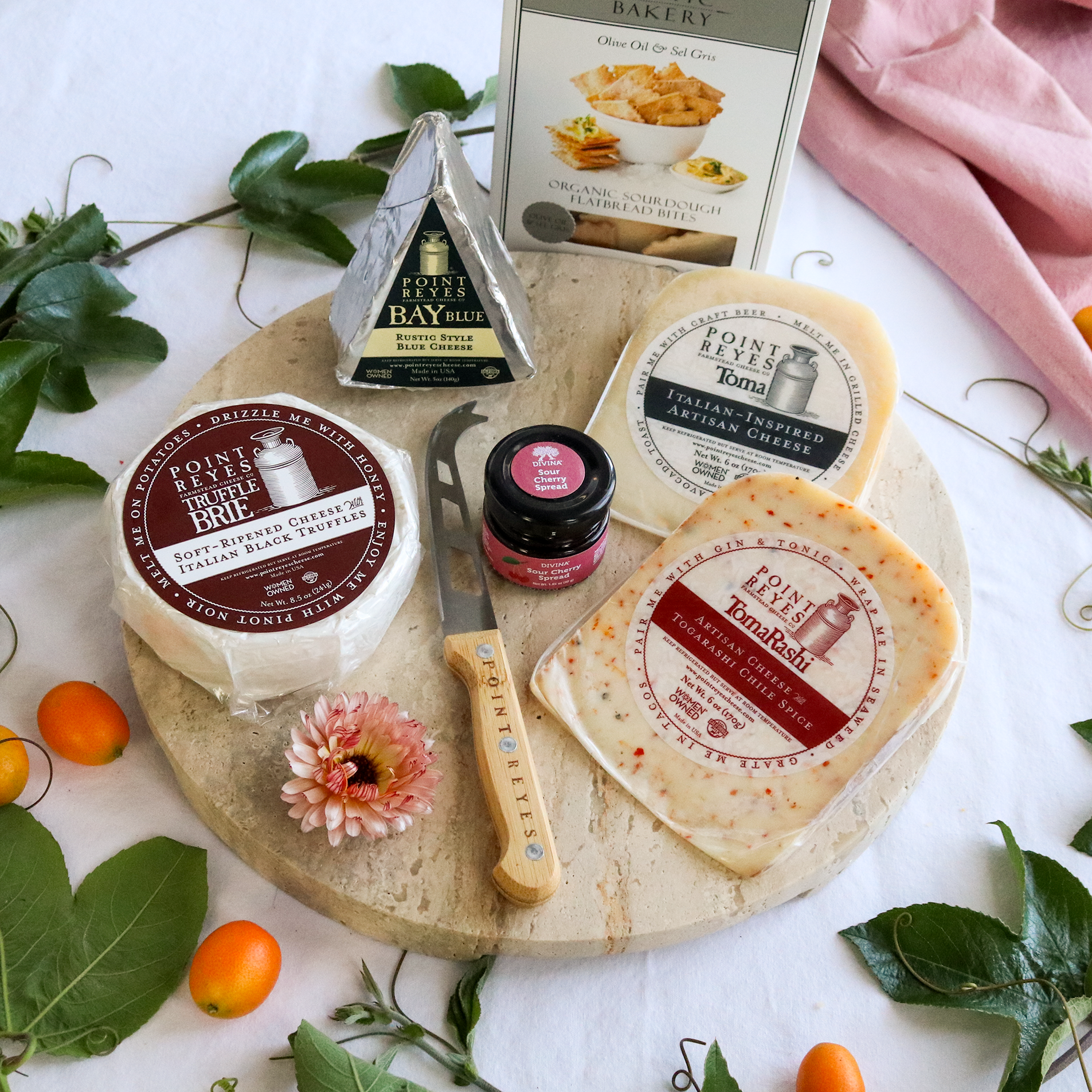packaged cheese and thank you cheese pack on a round board