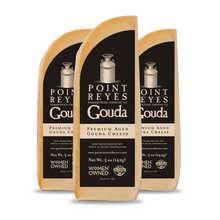 Three packages of Point Reyes Gouda cheese on a white background