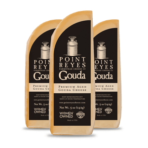 Three packages of Point Reyes Gouda cheese on a white background
