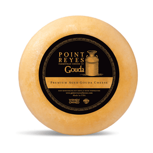 Point Reyes Gouda cheese wheel with a black label on a white background