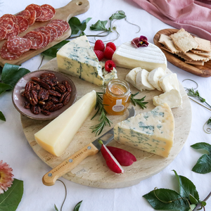 deluxe taste of point reyes cheese pack prepared on a round board