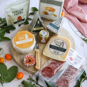 packaged deluxe taste of point reyes cheese pack on a round board