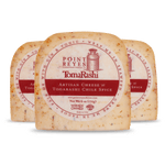 Three blocks of Point Reyes Togarashi Artisan Cheese on a white background
