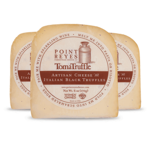 Point Reyes Toma Truffle cheese with label on a white background