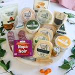 packaged celebration collection cheese pack on a round board
