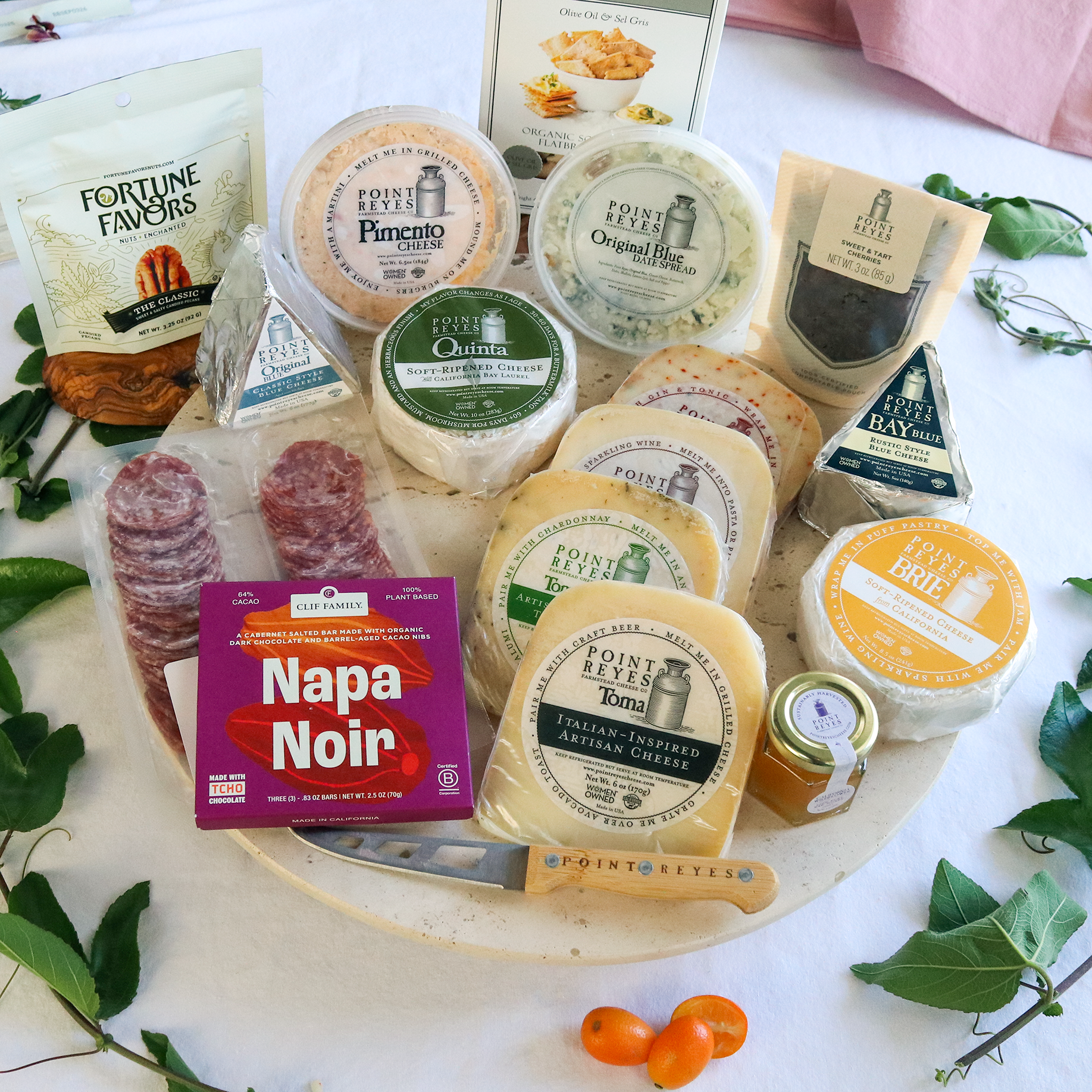 packaged celebration collection cheese pack on a round board