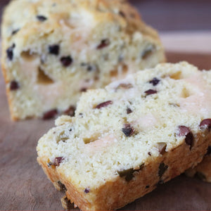 Aged Gouda and Olive quick bread on a brown cutting board